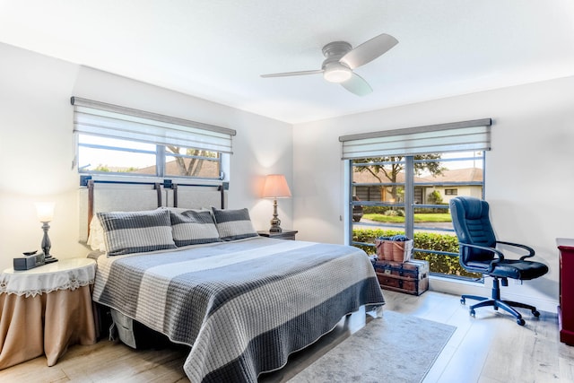 bedroom with light hardwood / wood-style floors, multiple windows, and ceiling fan