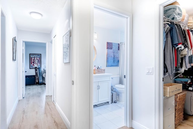 hall with light hardwood / wood-style flooring