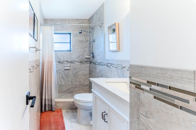 bathroom featuring vanity, tile patterned floors, tile walls, curtained shower, and toilet