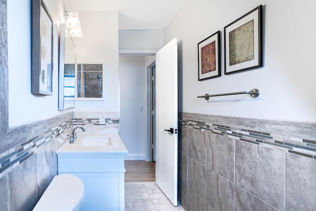 bathroom with vanity, toilet, and wood-type flooring