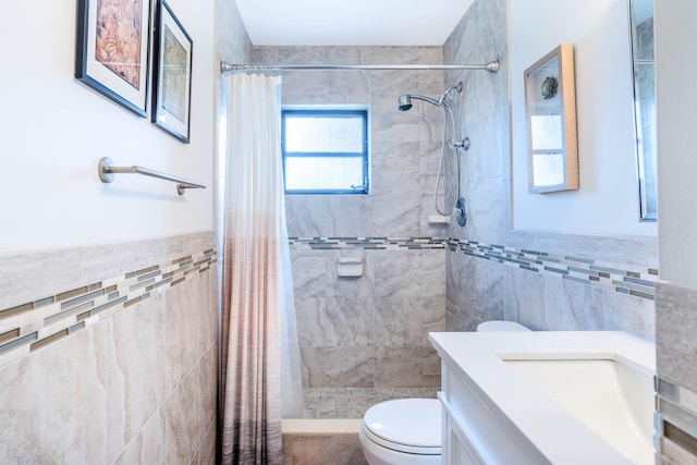 bathroom featuring vanity, walk in shower, tile walls, and toilet