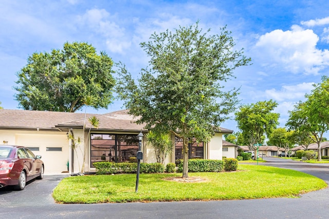 view of front facade with a garage and a front lawn