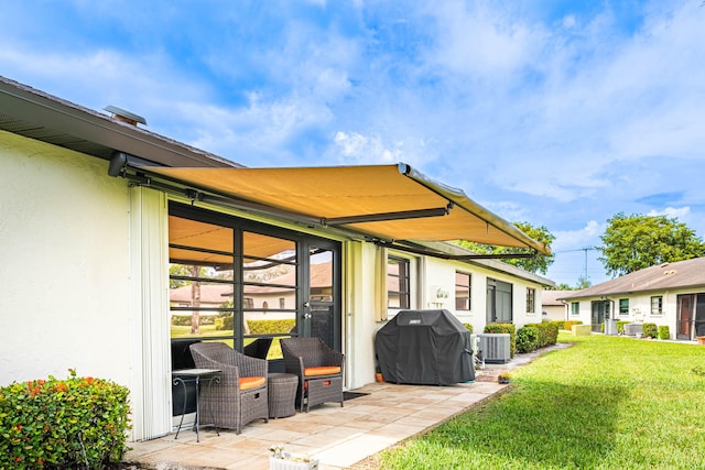 rear view of property featuring a patio, central air condition unit, and a lawn