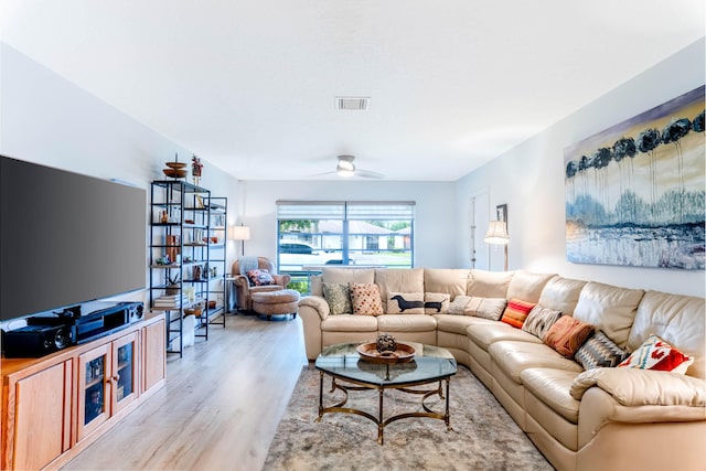 living room featuring ceiling fan and light wood-type flooring