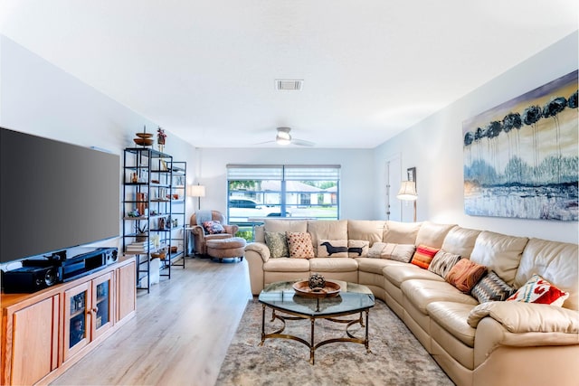 living room featuring ceiling fan and light hardwood / wood-style floors