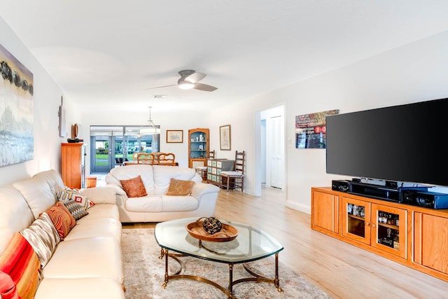 living room with ceiling fan and light wood-type flooring