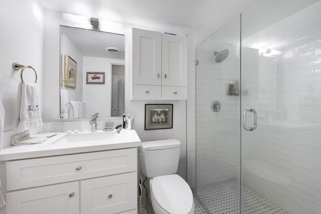 full bath featuring visible vents, vanity, toilet, and a shower stall