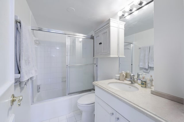 full bathroom with tile patterned flooring, enclosed tub / shower combo, vanity, and toilet