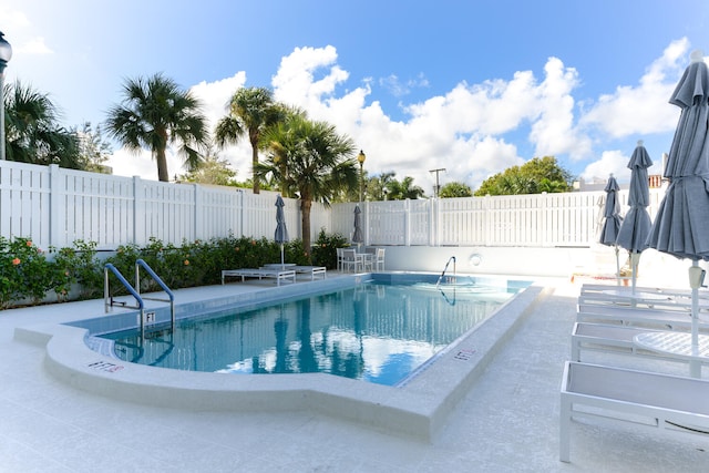 pool featuring a patio and fence