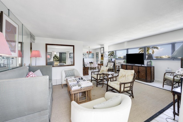 living area featuring light colored carpet and baseboards