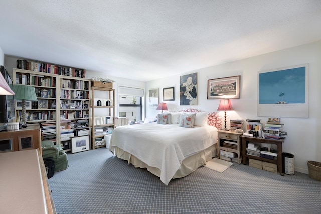 bedroom with a textured ceiling and carpet floors