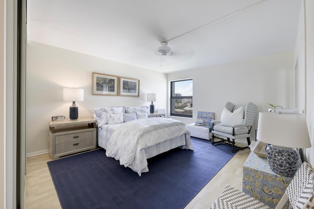 bedroom with light hardwood / wood-style flooring and ceiling fan