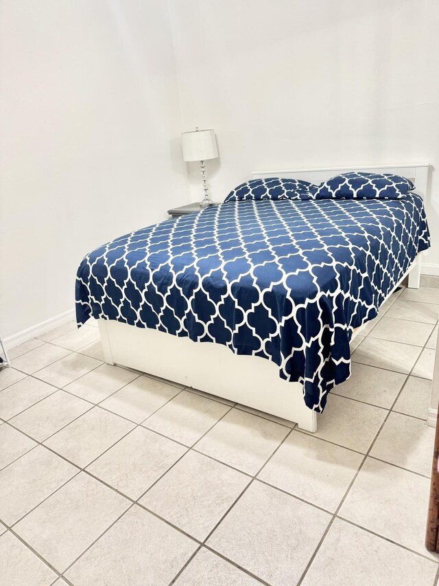 tiled bedroom with baseboards