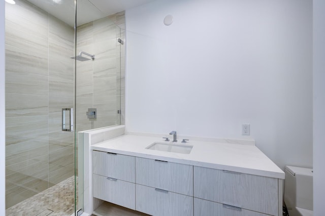 bathroom with walk in shower, vanity, and toilet