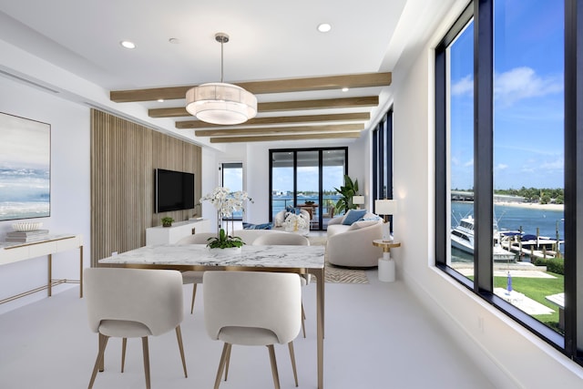 dining space with a wealth of natural light and beamed ceiling