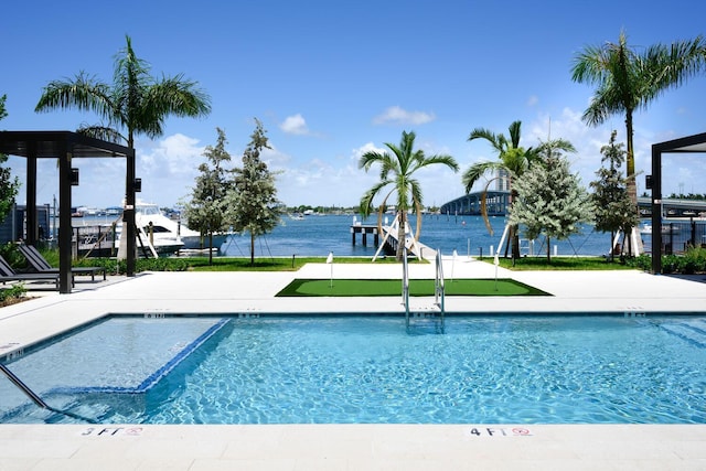 view of swimming pool featuring a water view