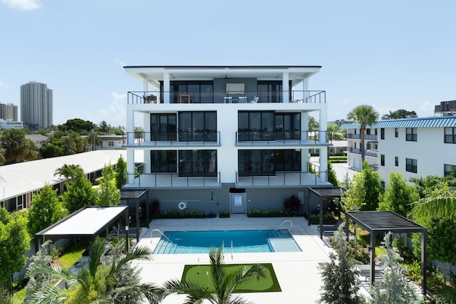 rear view of property with a patio area and a community pool