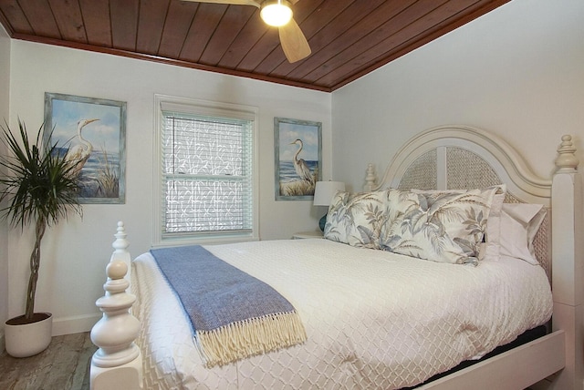 bedroom with ceiling fan, wood ceiling, crown molding, and hardwood / wood-style floors