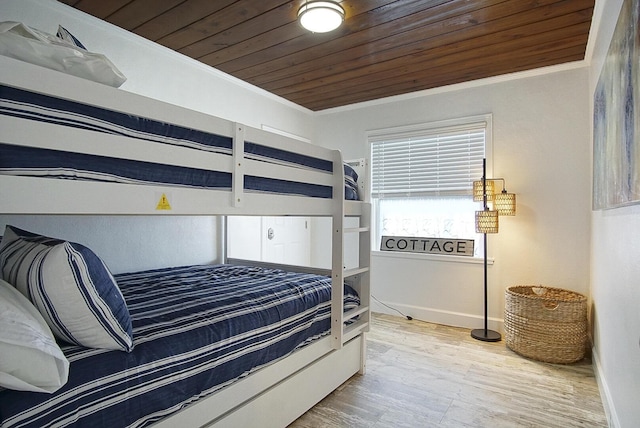 bedroom with wooden ceiling, crown molding, and hardwood / wood-style floors