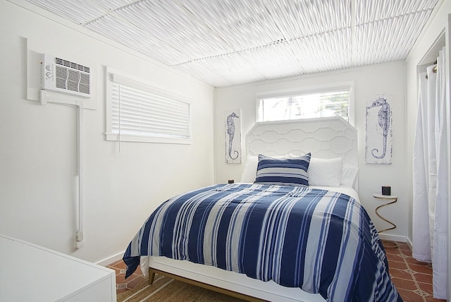 bedroom featuring a wall unit AC