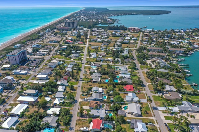 birds eye view of property featuring a water view and a beach view