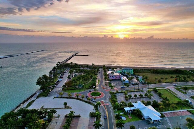 birds eye view of property featuring a water view and a view of the beach