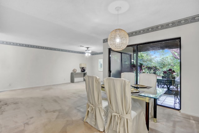 dining room with ceiling fan and light colored carpet