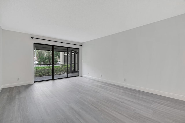 unfurnished room with light hardwood / wood-style flooring