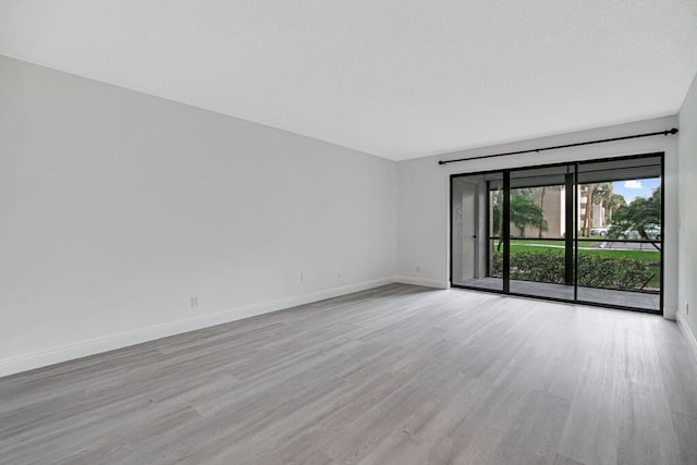 unfurnished room with light hardwood / wood-style flooring