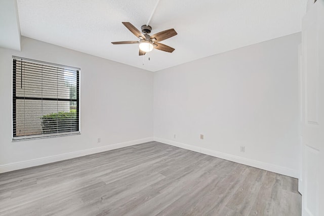 unfurnished room with ceiling fan and light wood-type flooring