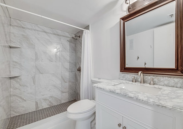 bathroom featuring toilet, vanity, and a shower with curtain