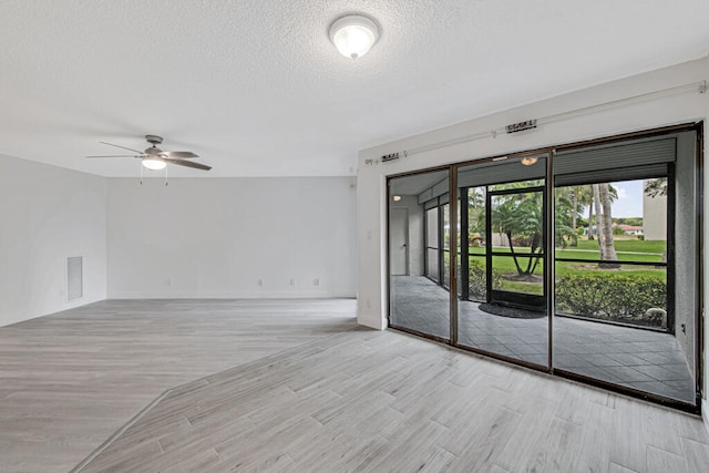 spare room featuring ceiling fan and a textured ceiling