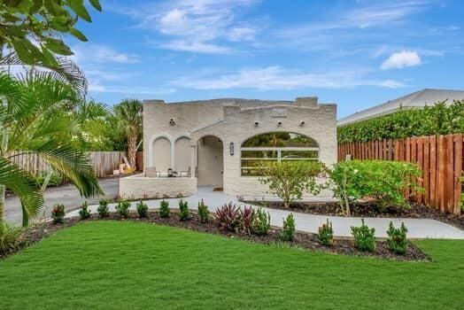 view of front of home featuring a front lawn, an outdoor kitchen, and fence private yard