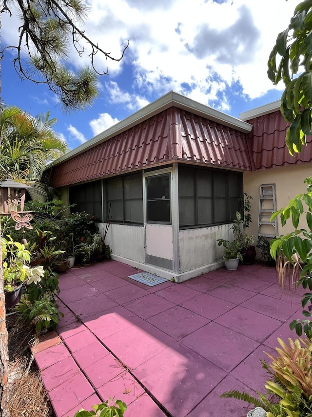 view of property exterior with a patio area