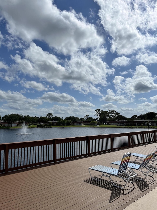 wooden terrace featuring a water view