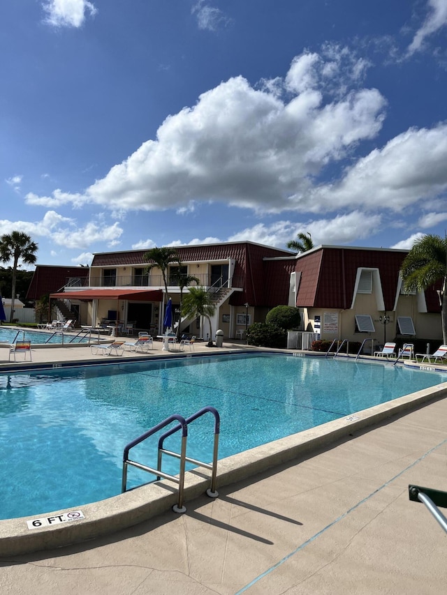 view of swimming pool with a patio