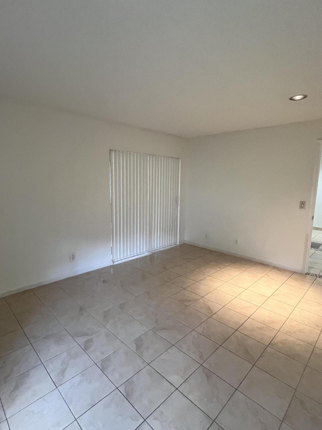 empty room with light tile patterned floors