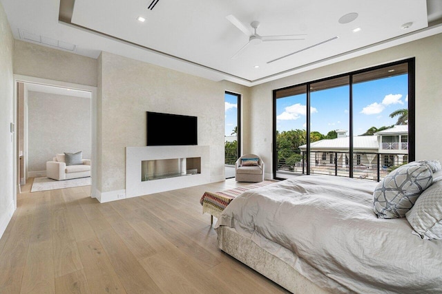 bedroom featuring light wood-type flooring, access to outside, and ceiling fan