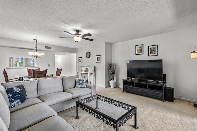 living room featuring a textured ceiling, light carpet, and ceiling fan