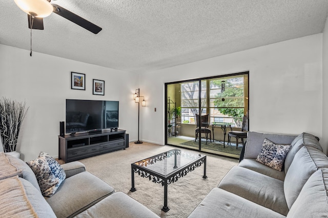 carpeted living room with ceiling fan and a textured ceiling