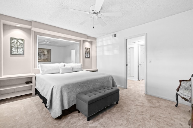 bedroom featuring light carpet, ceiling fan, and a textured ceiling