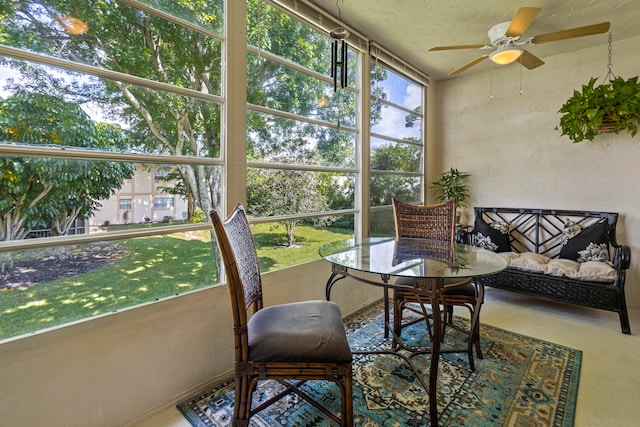 sunroom featuring a healthy amount of sunlight and ceiling fan