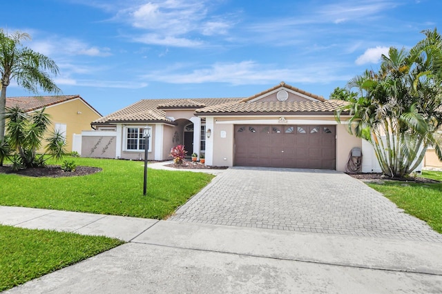 mediterranean / spanish-style house with a garage and a front yard