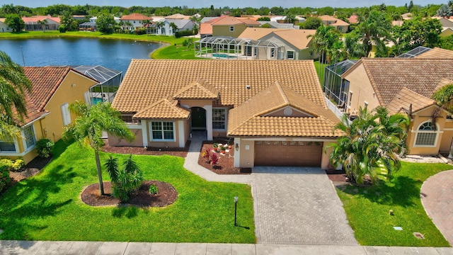 view of front of home featuring a garage, a water view, and a front yard