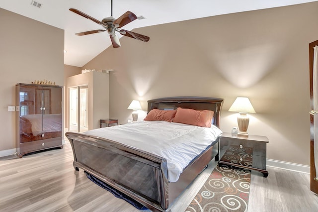 bedroom with a closet, high vaulted ceiling, ceiling fan, and light hardwood / wood-style flooring