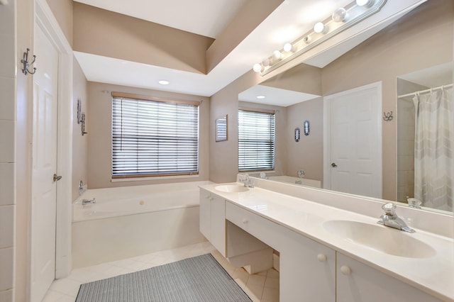 bathroom featuring tile patterned flooring, vanity, and a bathtub