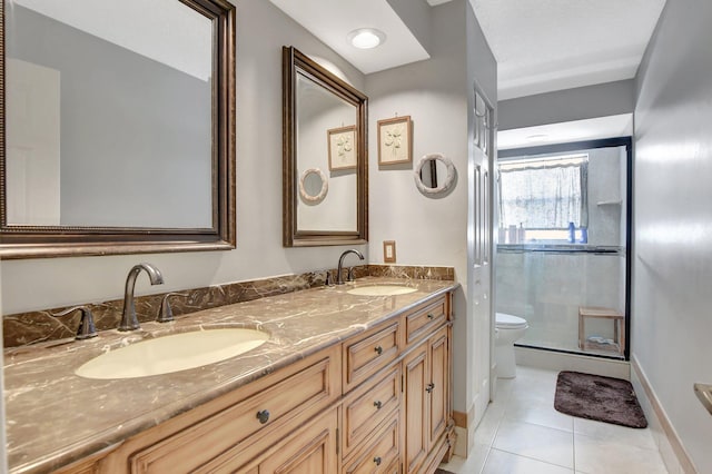 bathroom with vanity, toilet, an enclosed shower, and tile patterned flooring