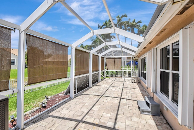 unfurnished sunroom featuring vaulted ceiling