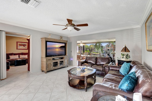 living room featuring light tile patterned flooring, ceiling fan, ornamental molding, and a textured ceiling