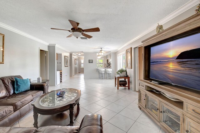 tiled living room with ceiling fan, crown molding, and a textured ceiling